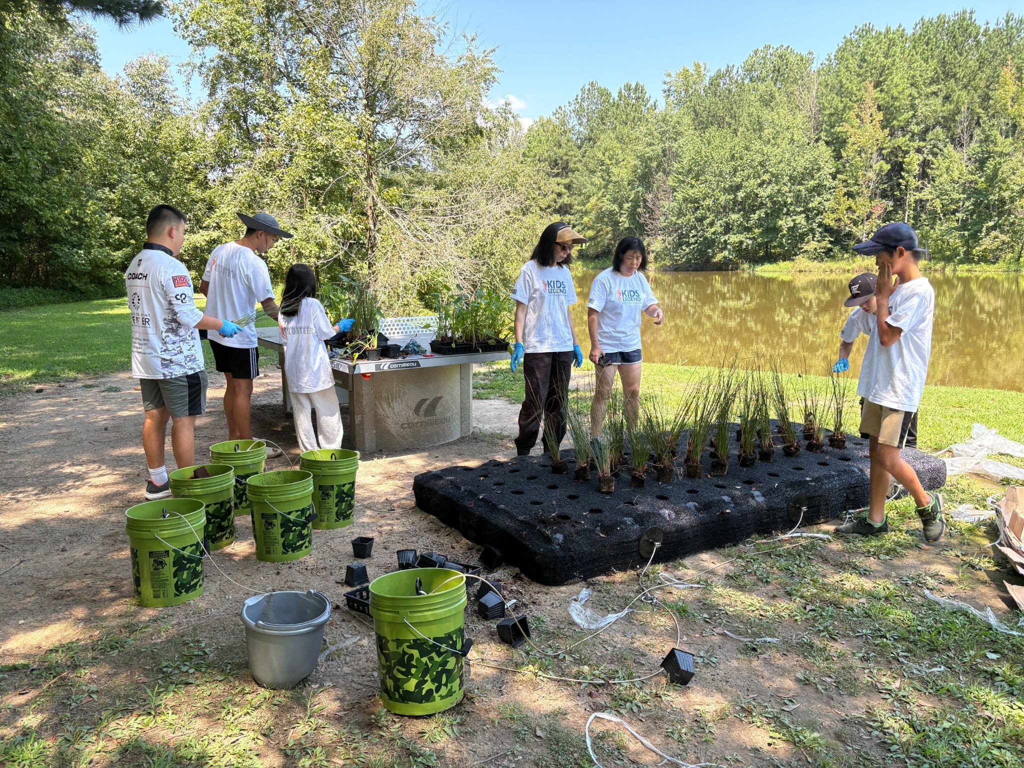 EcoAngler volunteers preparing the floating wetland with plants